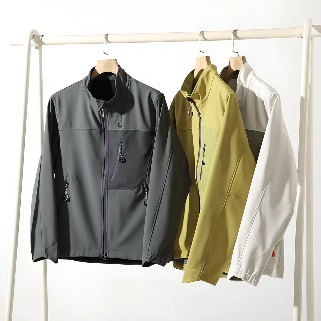 Men's retro patchwork contrast colour stand-up collar coat in Misty White, side view showing zipped pockets