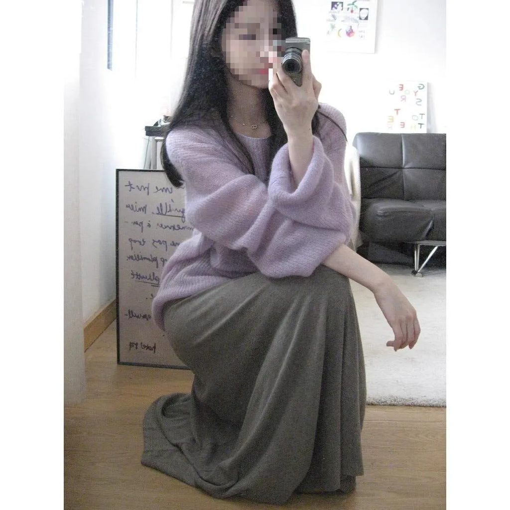 Purple women's blouse with hollow out design and princess sleeves on a hanger.