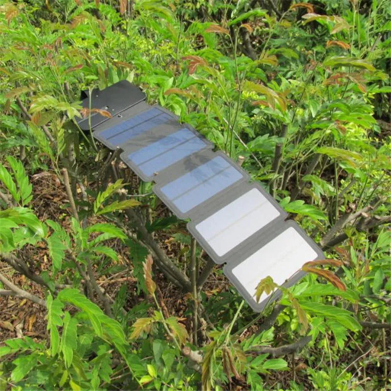 Folding solar panel charger with monocrystalline silicon cells, USB output, and compass buckle in black