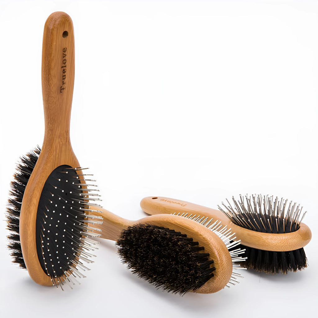 Medium pet deshedding comb with bamboo handle and stainless steel needles in original bamboo colour on a flat surface