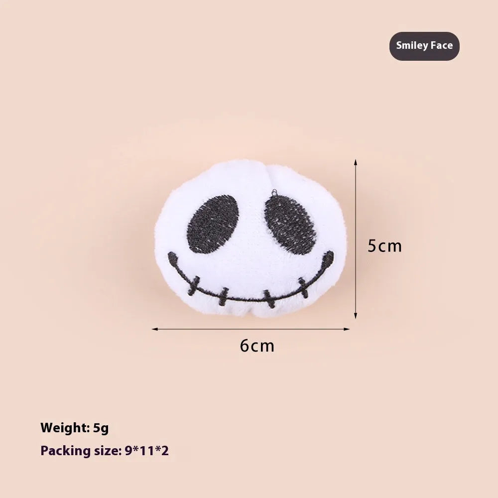Small handheld cat teaser with plush candy and eyes attachments on wand