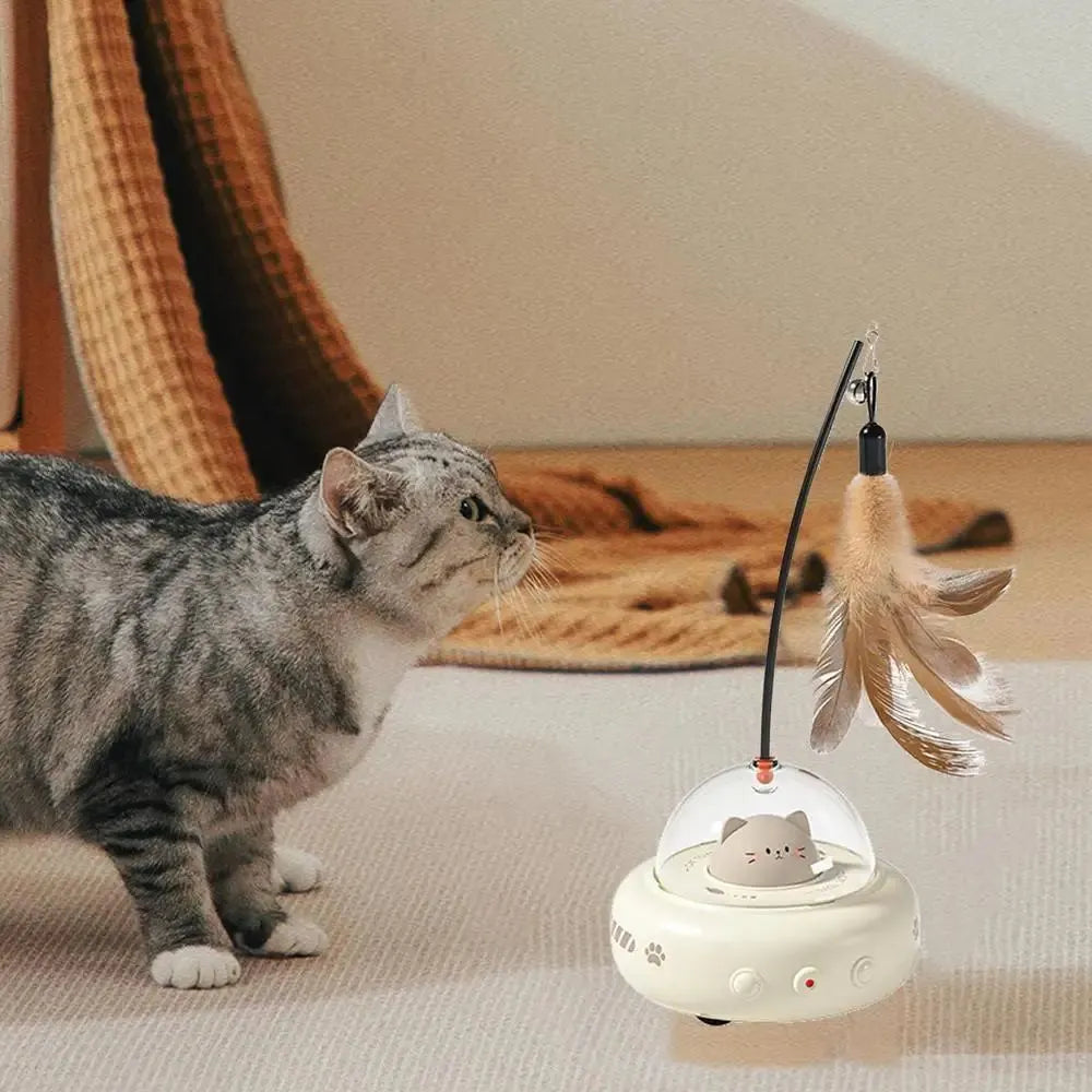 Electric cat interactive toy with pink feather wand and red light beam on a white floor
