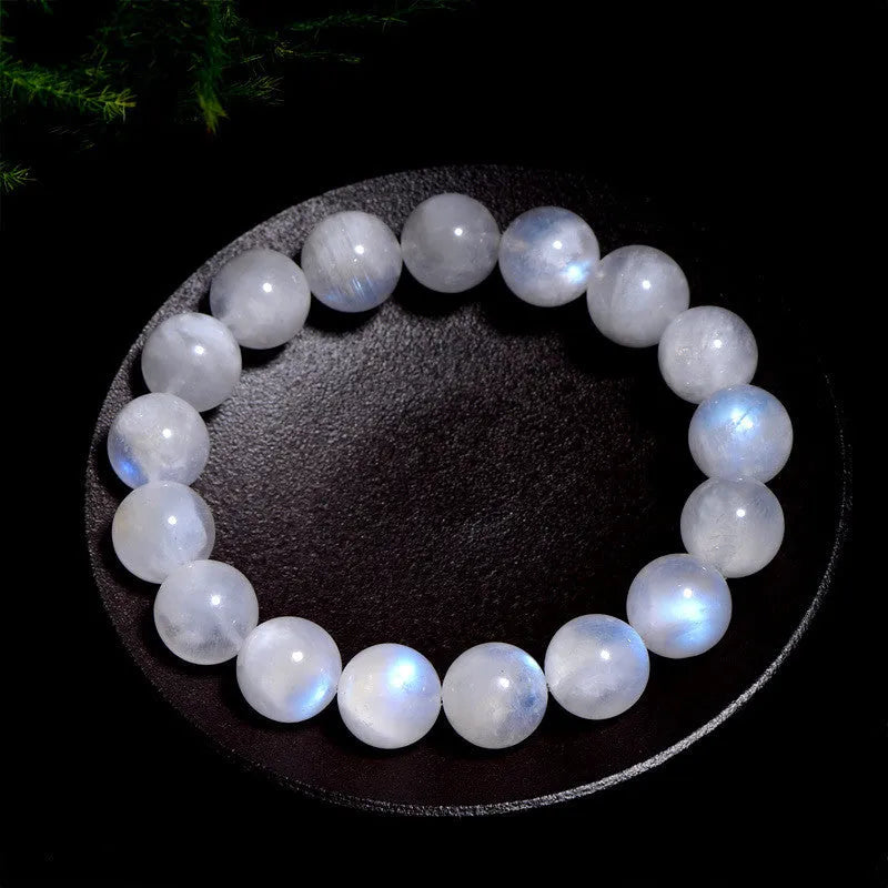 Natural blue moonlight coloured moonstone round bead bracelet on a white background.