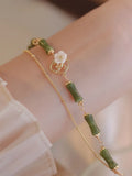 Natural olivine bracelet with Chinese double layer design featuring twin Bells of Ireland elements