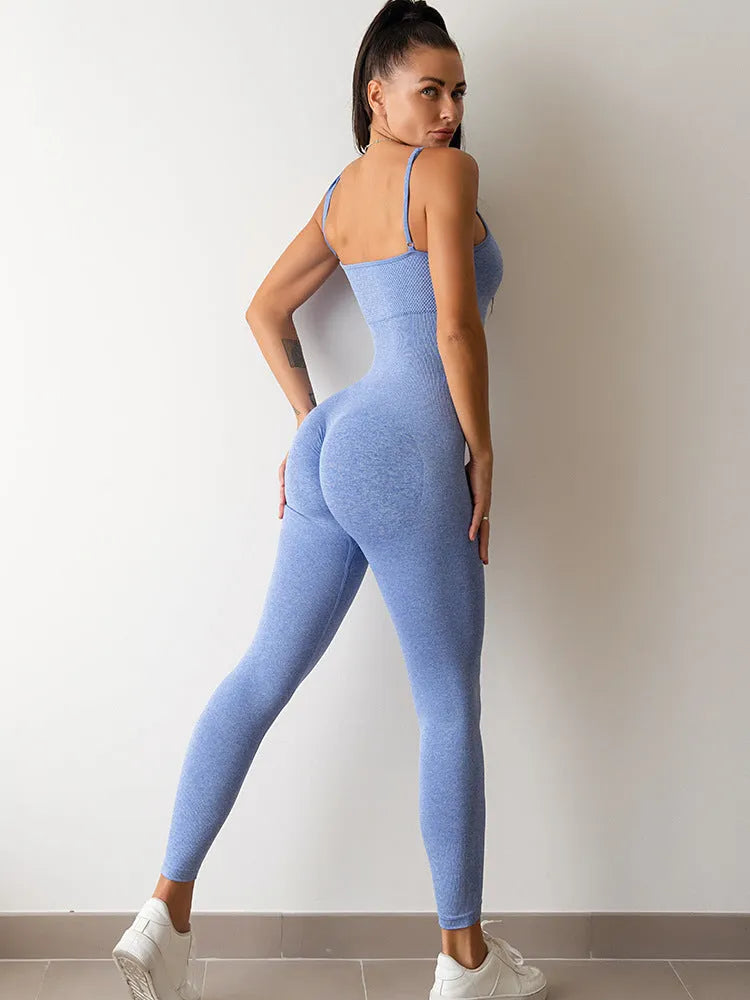 A woman wearing a black sleeveless unitard jumpsuit with spaghetti straps, showcasing its tight fit and backless design.