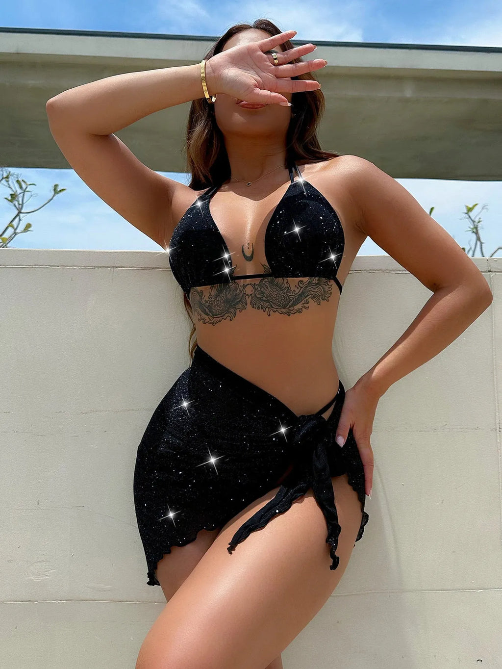 Black three-piece swimsuit bikini set with high-waisted shorts on mannequin