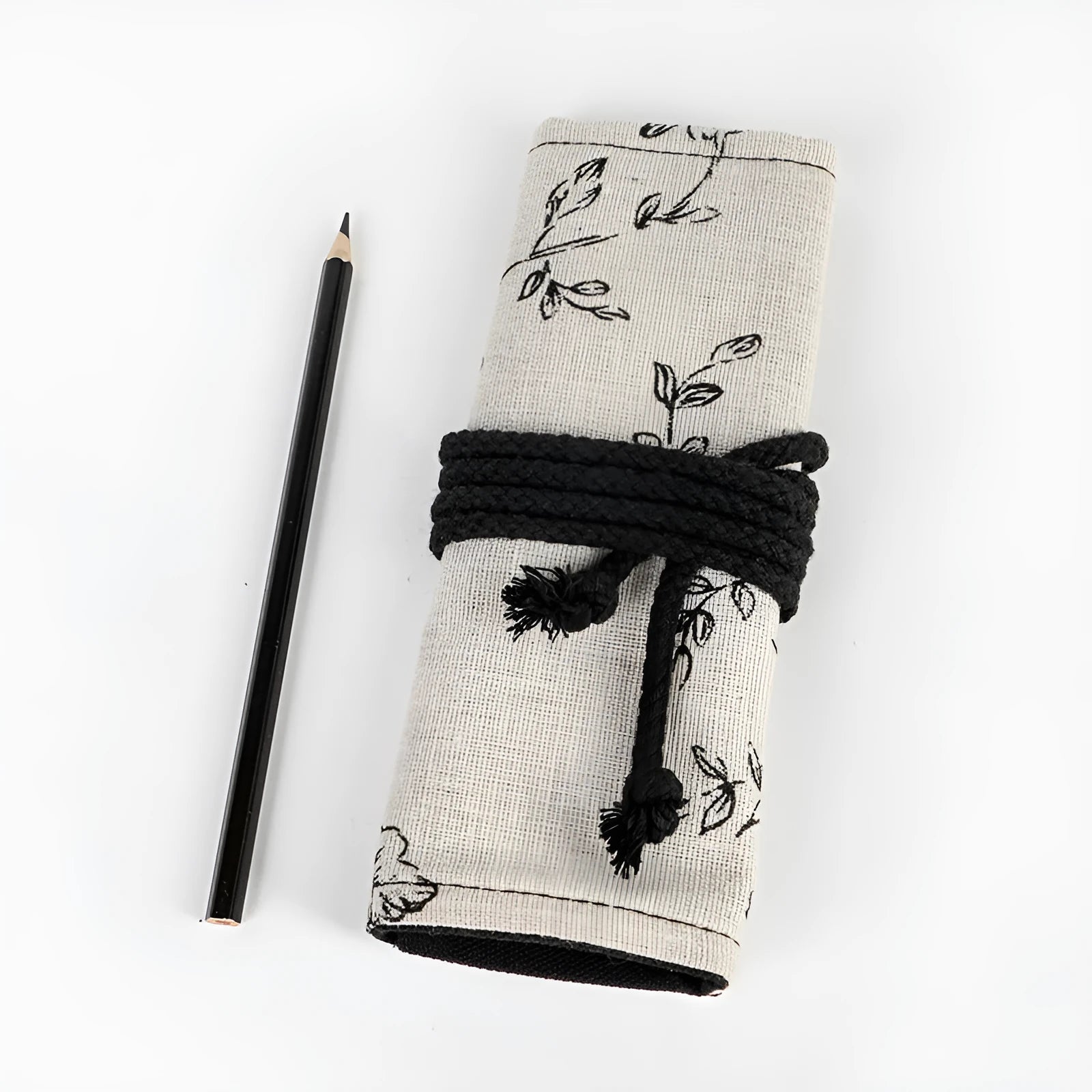 Black peony floral print canvas pencil roll bag unrolled to show 24 or 72 holes for pens.