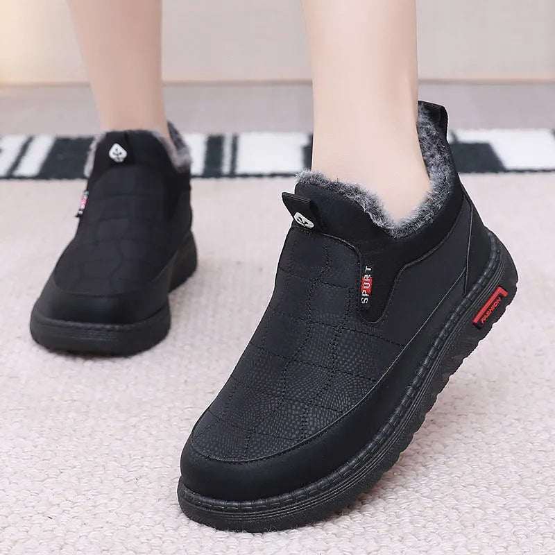 Women's black casual flat ankle boots with a round toe and non-slip rubber sole.