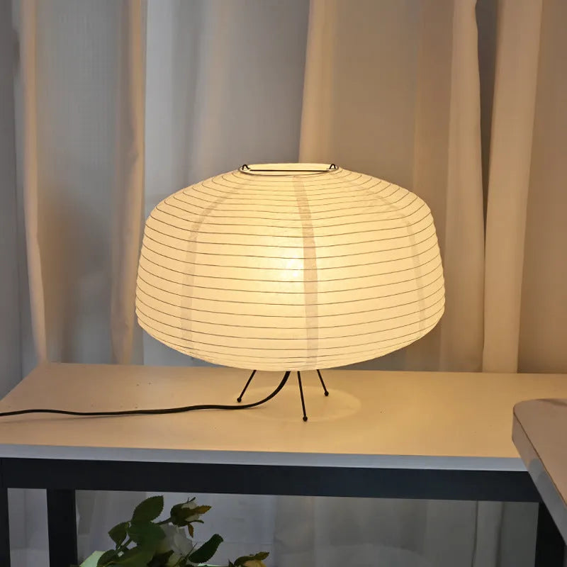 Japanese style xuan paper desk lamp on a wooden desk with soft warm light
