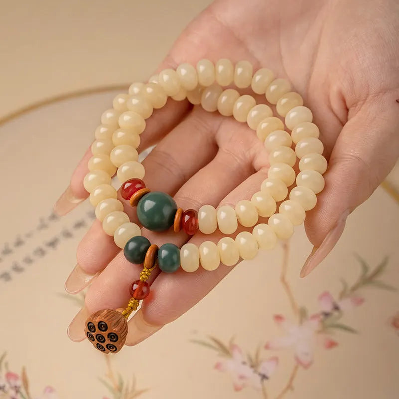 Milk butter coloured Bodhi root wood bracelet with 6x9mm flat round beads on wrist