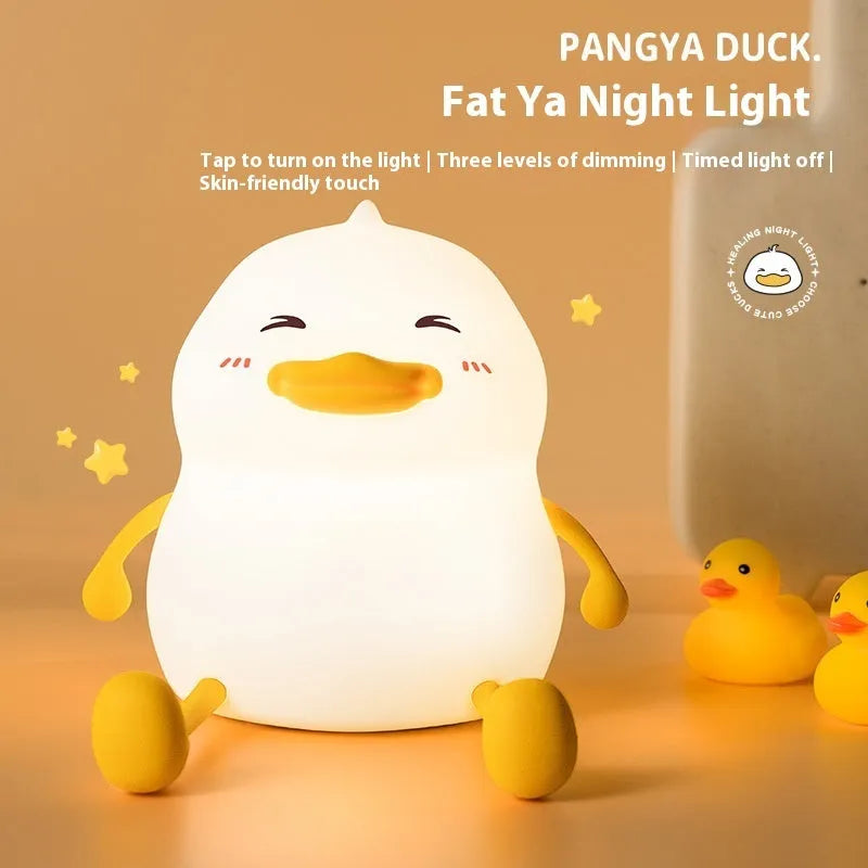 Chubby Night Light on a desk showing its compact size and silicone phone holder feature.