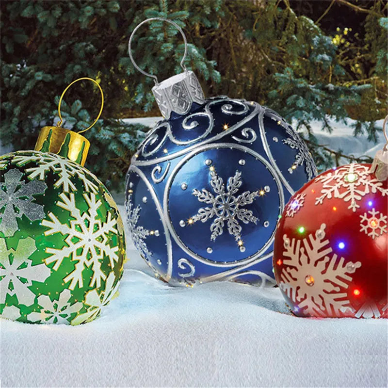 Large red and white striped inflatable Christmas ball ornament hanging on an outdoor tree