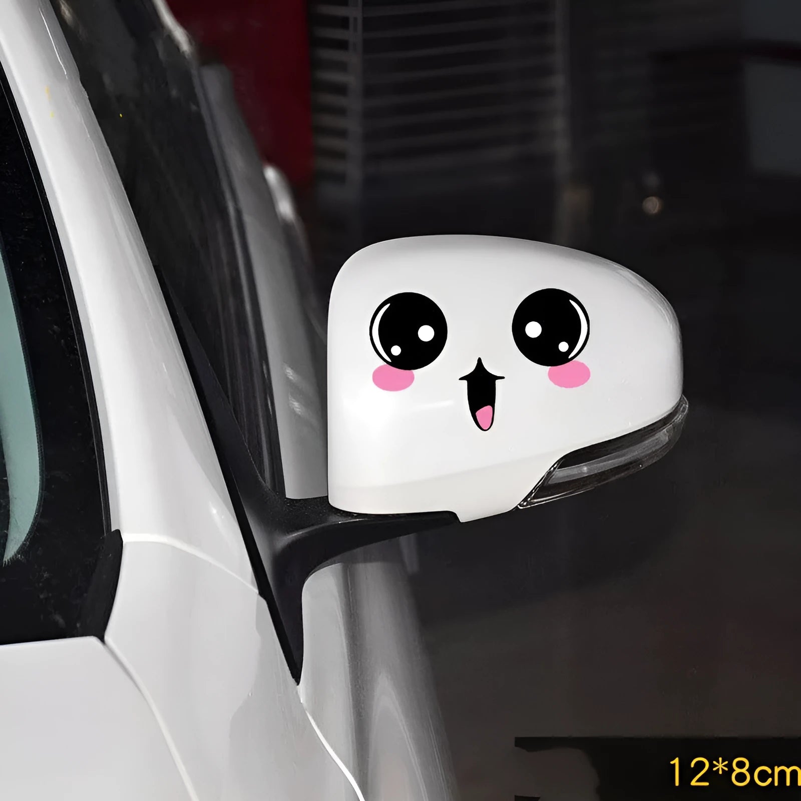 Pair of reflective cartoon eye car stickers on a vehicle rearview mirror.