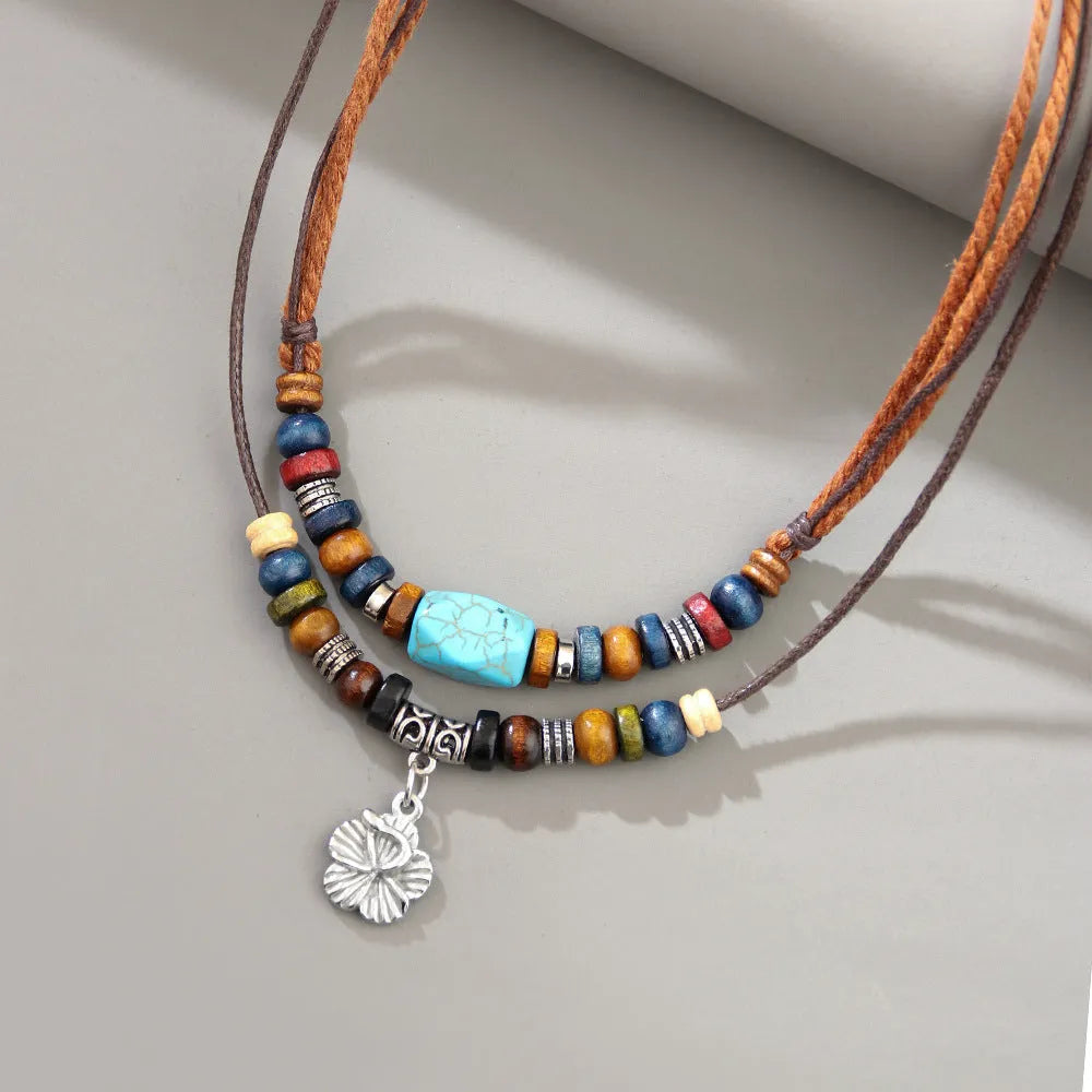 Wooden bead necklace with alloy floral pendant and turquoise wax rope in retro design