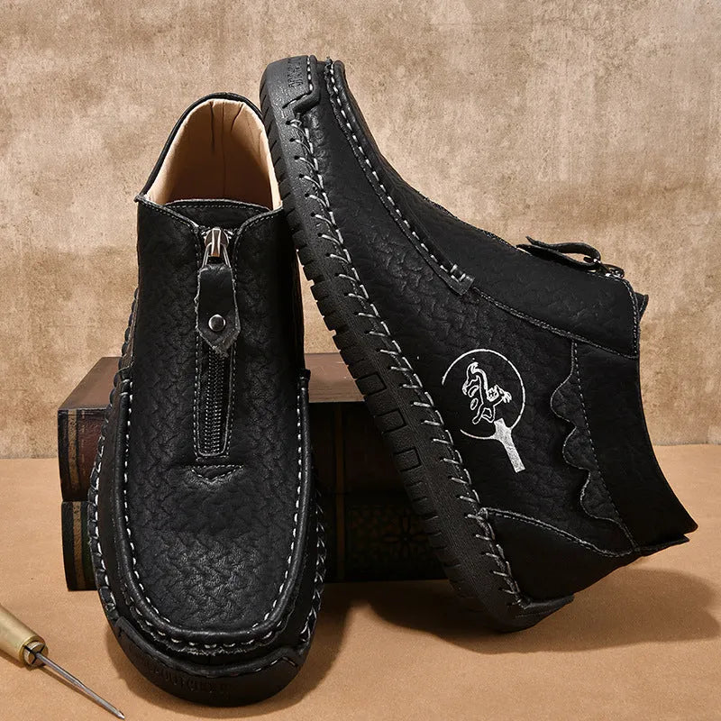 Men's black slip-on loafers with round toe and visible stitching on a rubber sole.