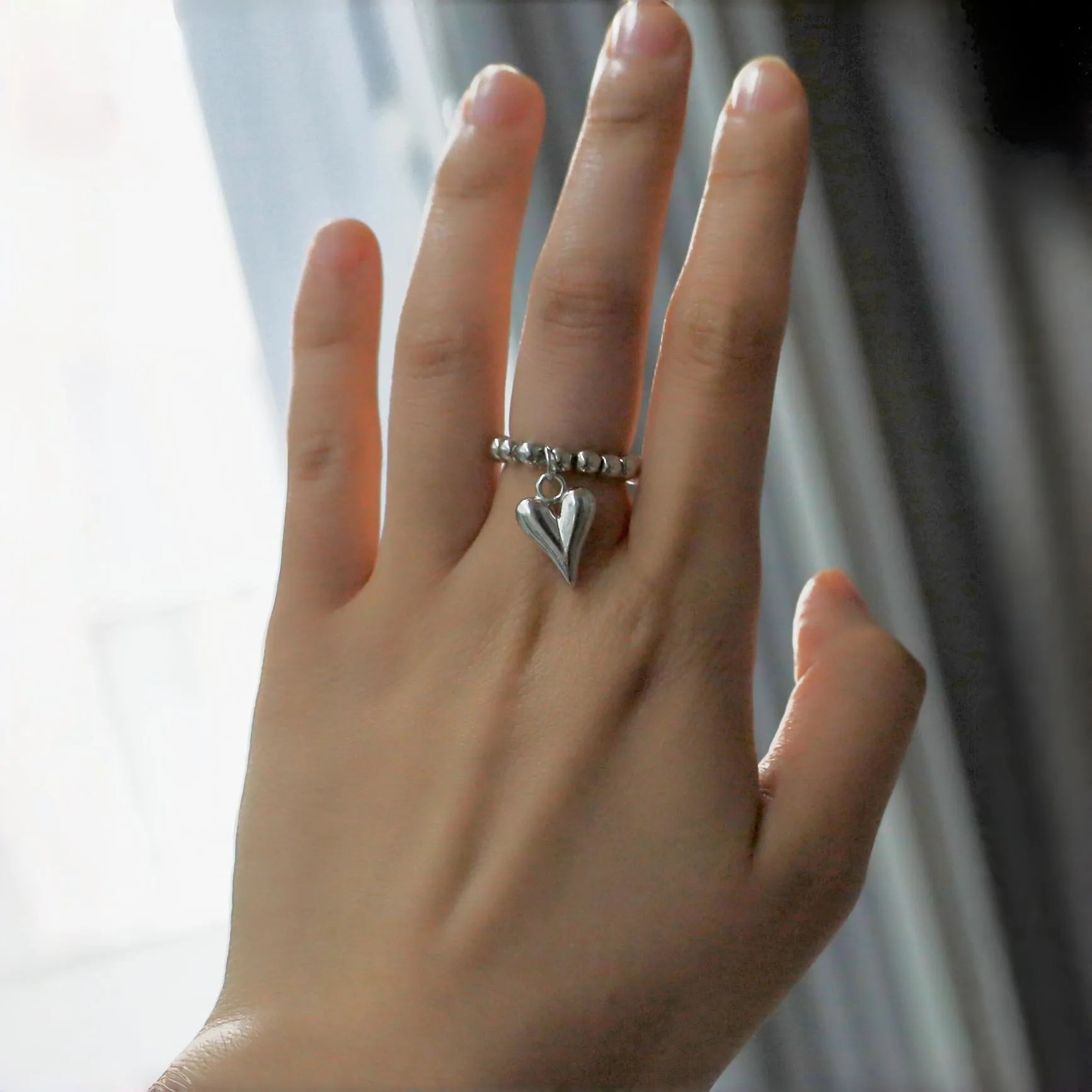 Handmade beaded elastic string love ring with geometric heart design in gold and white colour options
