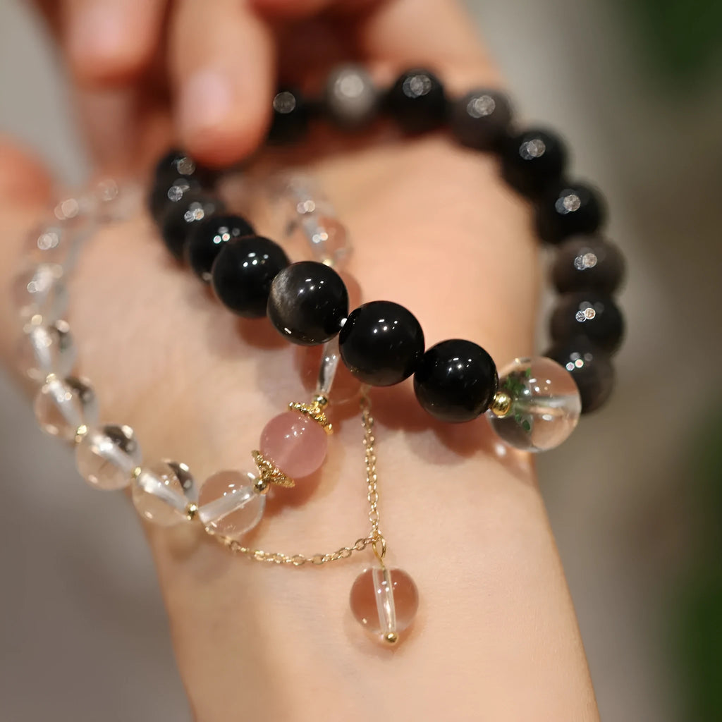 White crystal bracelet with geometric Chinese auspicious patterns and cat eye obsidian detailing