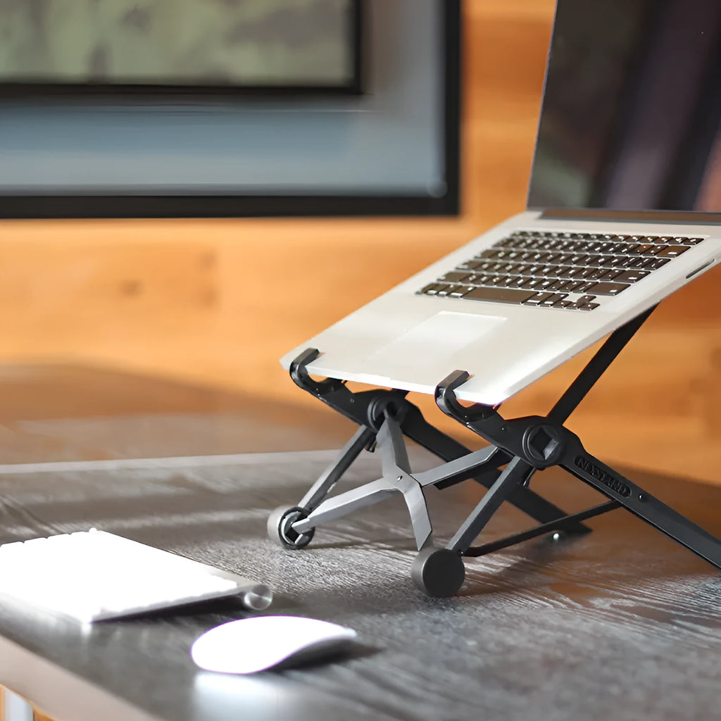 Sagacious black foldable laptop stand with enhanced nylon construction on desk
