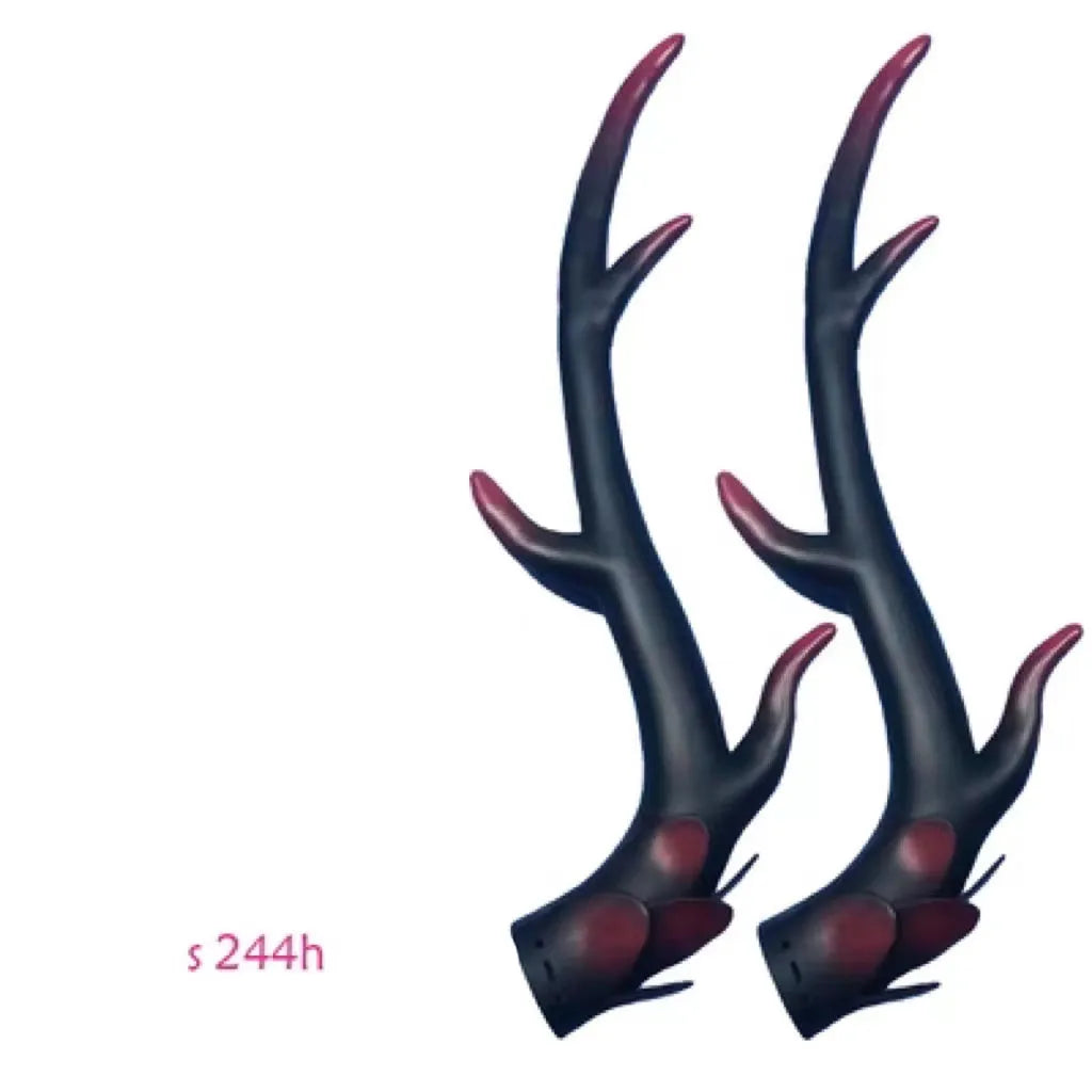 A pair of resin dragon horn decorations for motorcycle helmets in black, shown next to a ruler for scale.