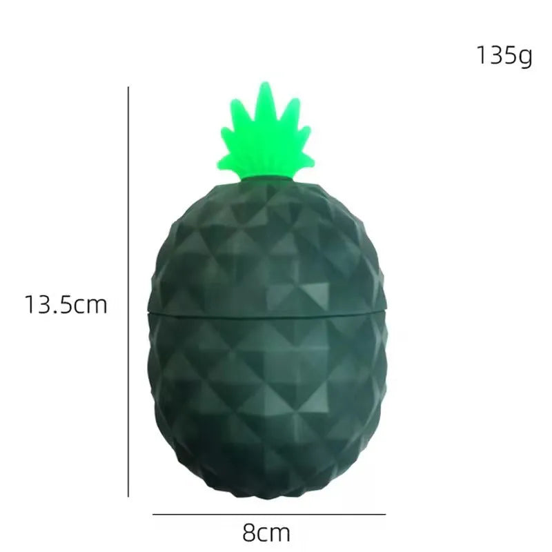 Silicone facial ice mold in pineapple style, pink colour, with ice cubes on a white background
