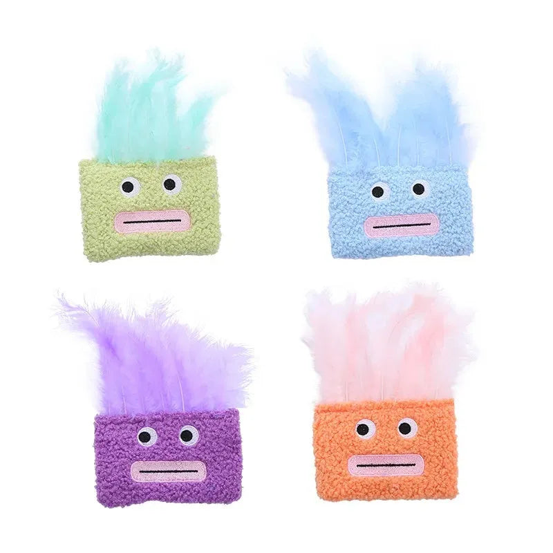 Colourful catnip plush toy with a funny big mouth explosion head shape on a blue background.