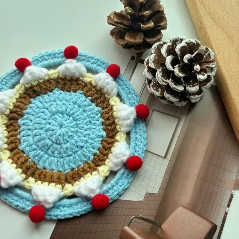 Round 9cm grey felted wool coaster next to its drawstring storage pouch.