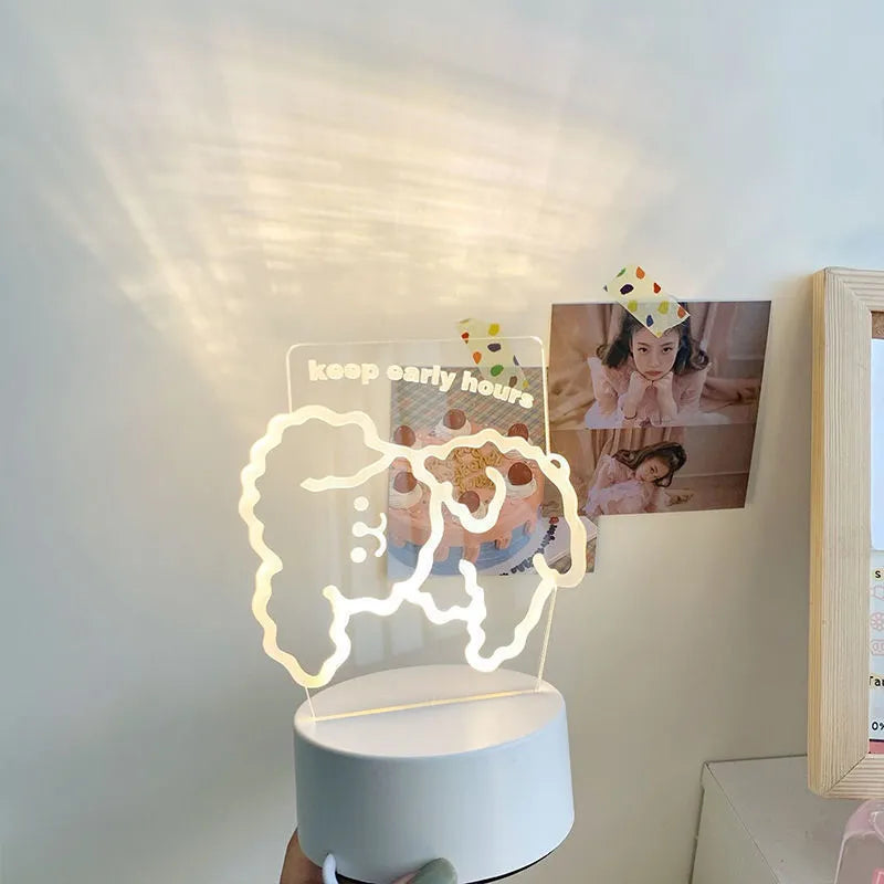 Teddy bear cartoon LED night light with acrylic shade on a table, USB cable attached