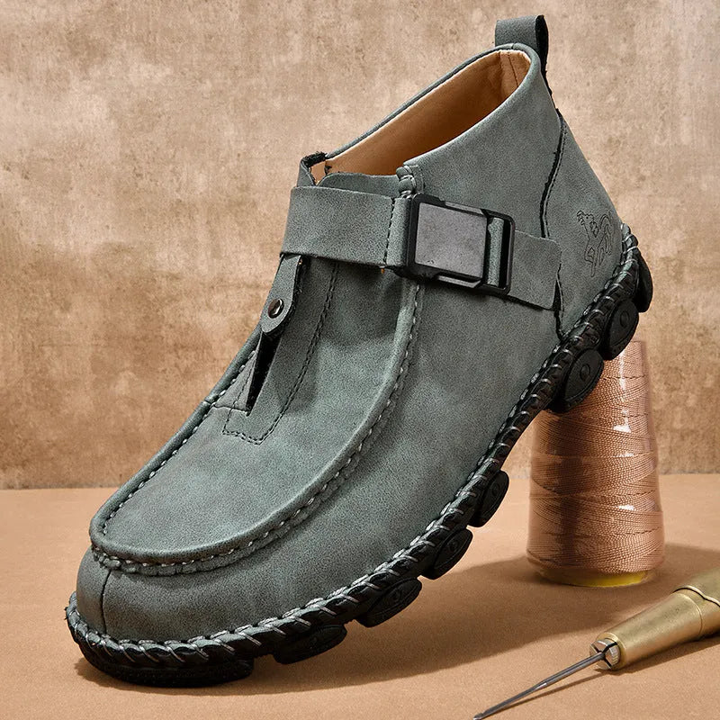 Casual flat slip-on shoes in black synthetic PU leather with visible handmade stitching around the sole.