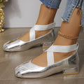 Gold slip-on square toe evening pumps with a low heel on a white background.