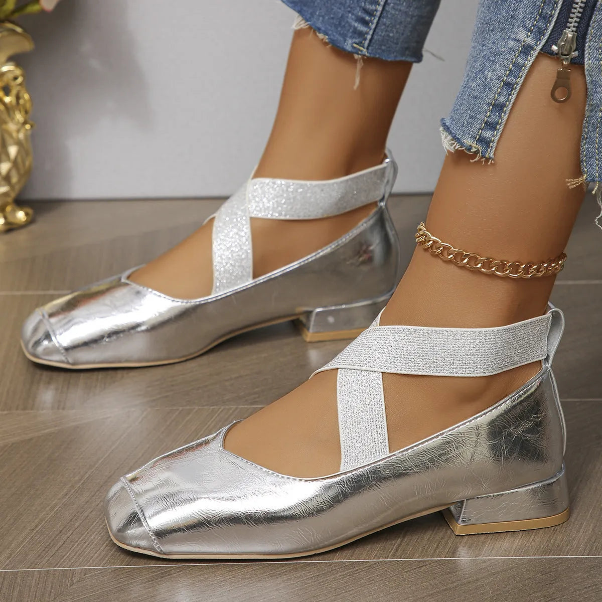 Gold slip-on square toe evening pumps with a low heel on a white background.