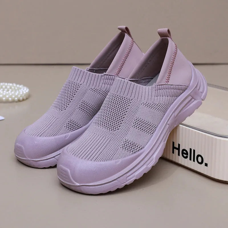 Women's black slip-on shoes with cloth upper and PVC sole showing one pedal design