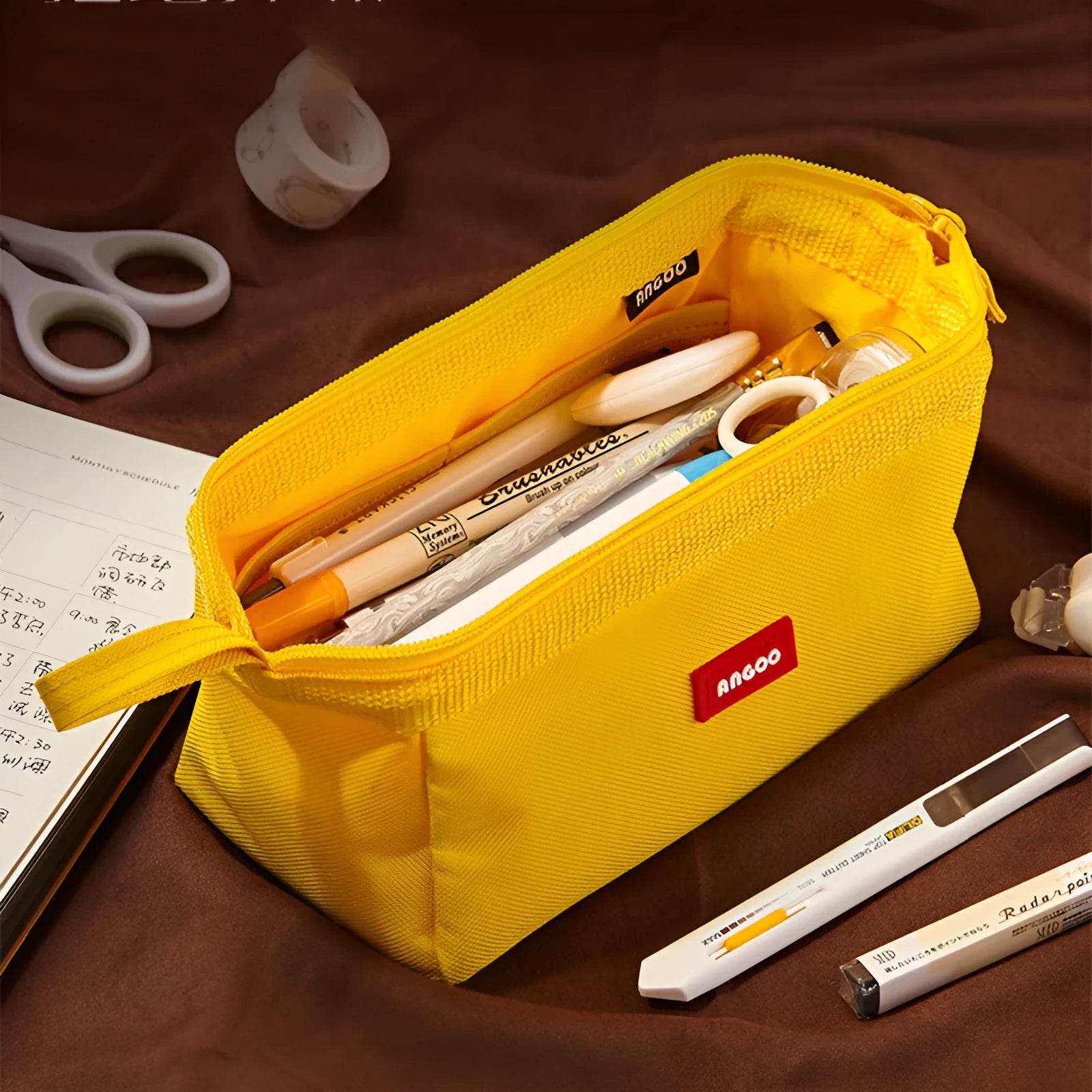 Large-capacity oxford cloth pencil case with a double zipper, shown in yellow, black, and dark blue colour options.