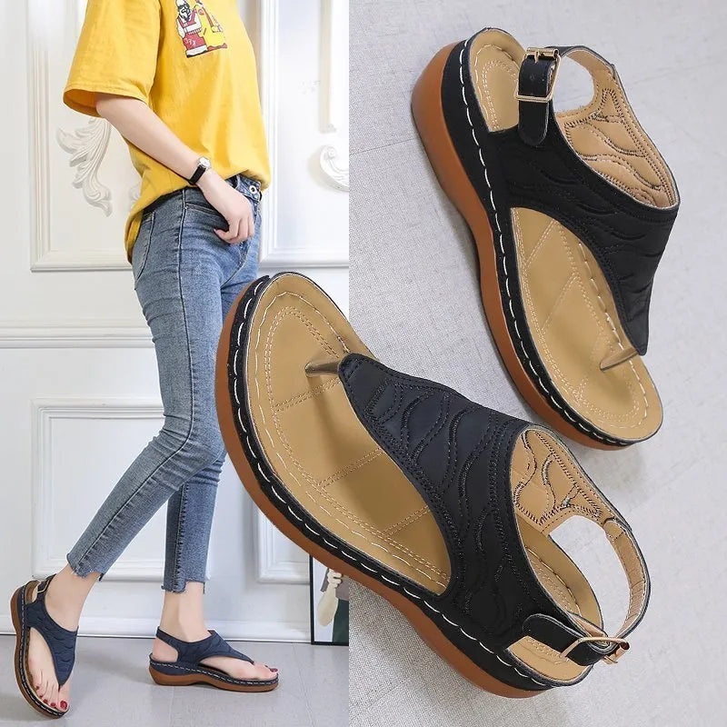 Women's solid colour wedge heel flip flop sandals with an adjustable buckle strap.