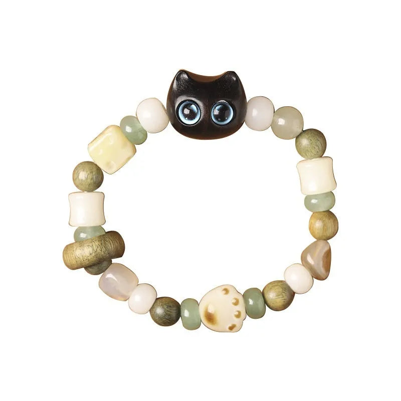 Hand-woven multi-treasure bracelet with Bodhi seeds, jade, and wood beads featuring a cat's paw charm.