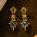 Gold geometric stud earrings with round element and diamond treatment