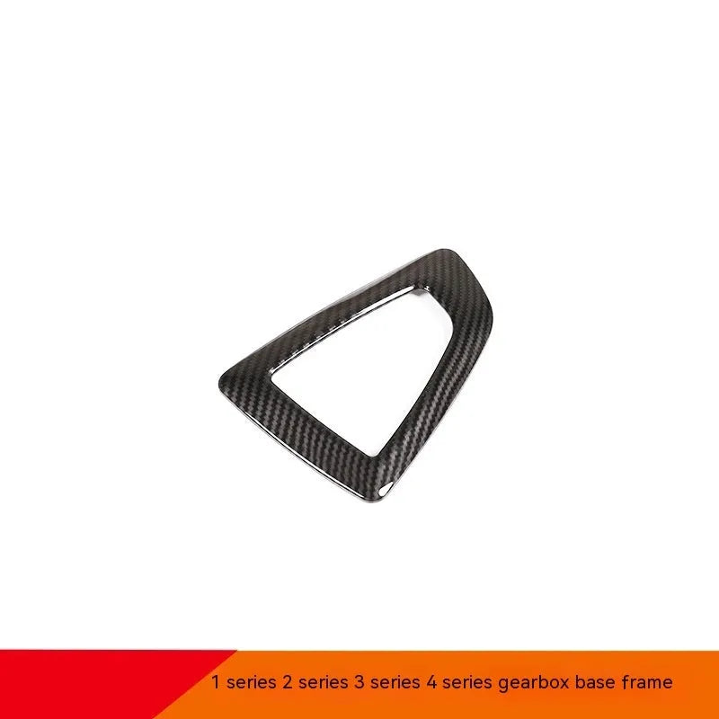 BMW gear selector base frame in carbon fibre pattern left titanium colour, showing 3M adhesive backing.