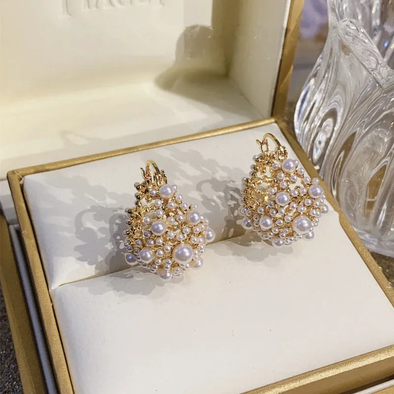 Gold floral basket earrings with pearl inlay and rice-shaped bead construction
