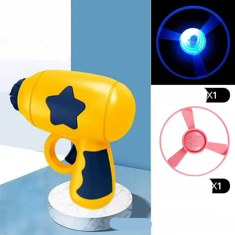 Blue flying saucer launcher gun and three LED flashing discs on a yellow background.