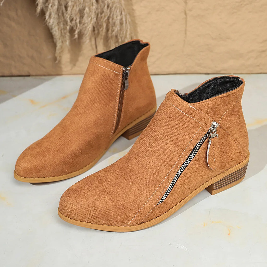 Suede women's ankle boots with side zipper in beige, shown on a white background