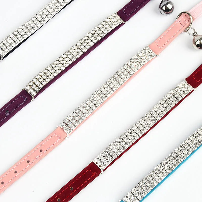 Adjustable red velvet cat collar with rhinestone decoration on a white background