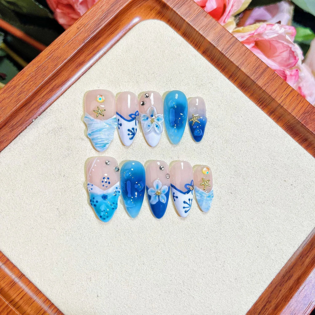 Blue hand-painted false nails with carved summer ice transparent design in sizes XS to L
