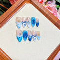 Blue hand-painted false nails with carved summer ice transparent design in sizes XS to L