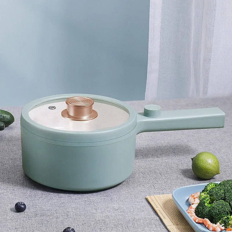 White and green multi-function electric cooking pot with control panel, 600W power, and compact design.