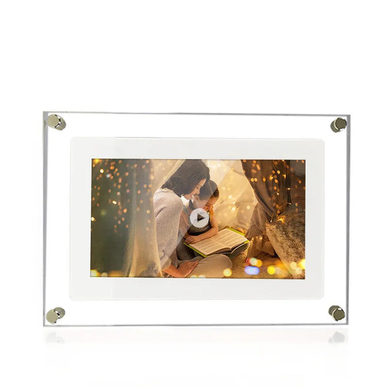 White vertical digital picture frame with acrylic casing on a table, showing a family photo on screen.