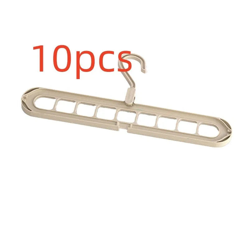Green plastic nine-hole multifunctional clothes hanger for trousers on a white background.