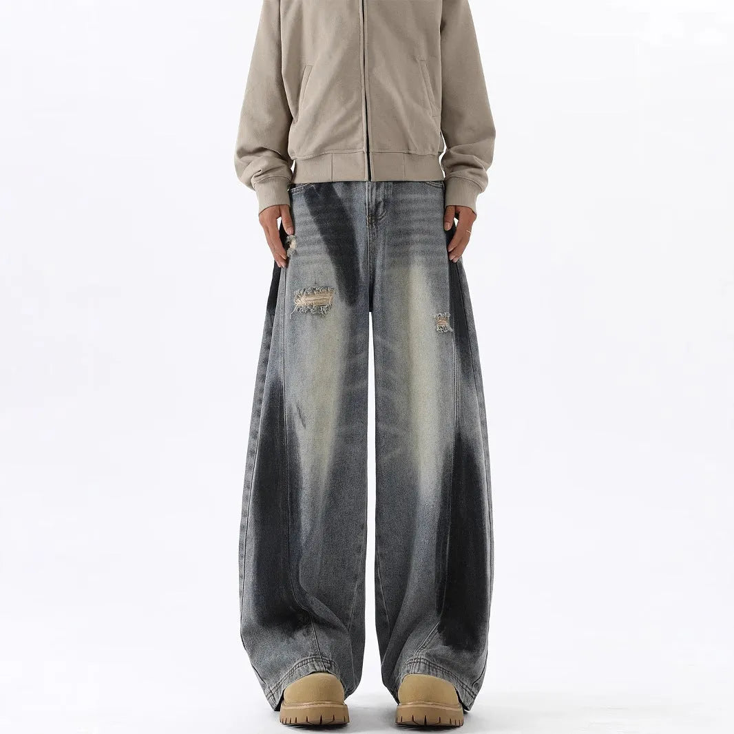 Men's blue ripped jeans with splash-ink wash pattern and loose fit silhouette