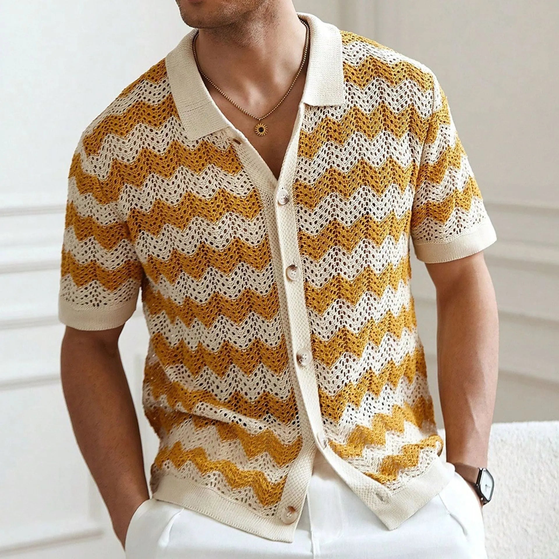 Blue hollow jacquard corrugated short sleeve sweater with flocked detail on a hanger.