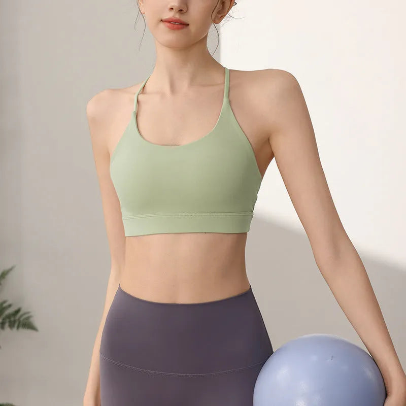 Women's nylon sports vest with fixed double-shoulder straps on a hanger