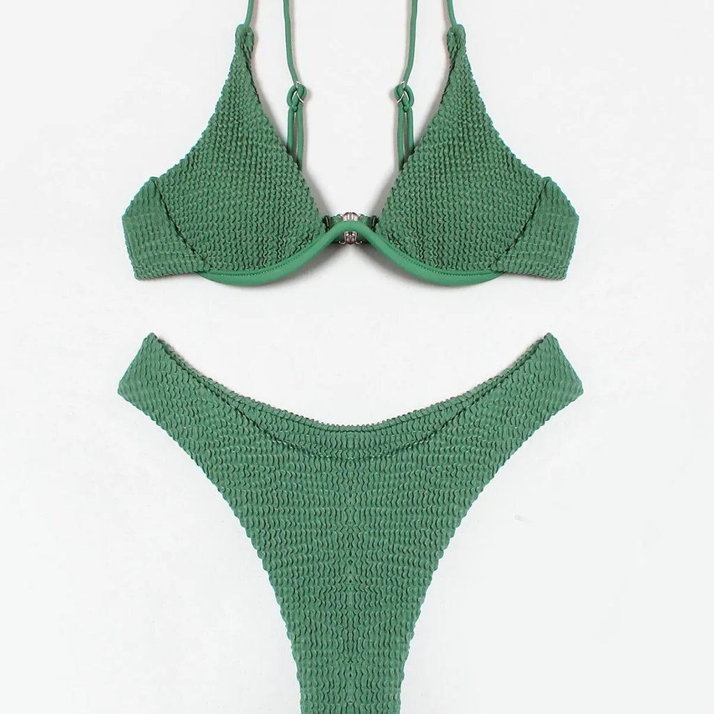 Women's solid green bikini suit with ruffle detailing and split-front design on mannequin