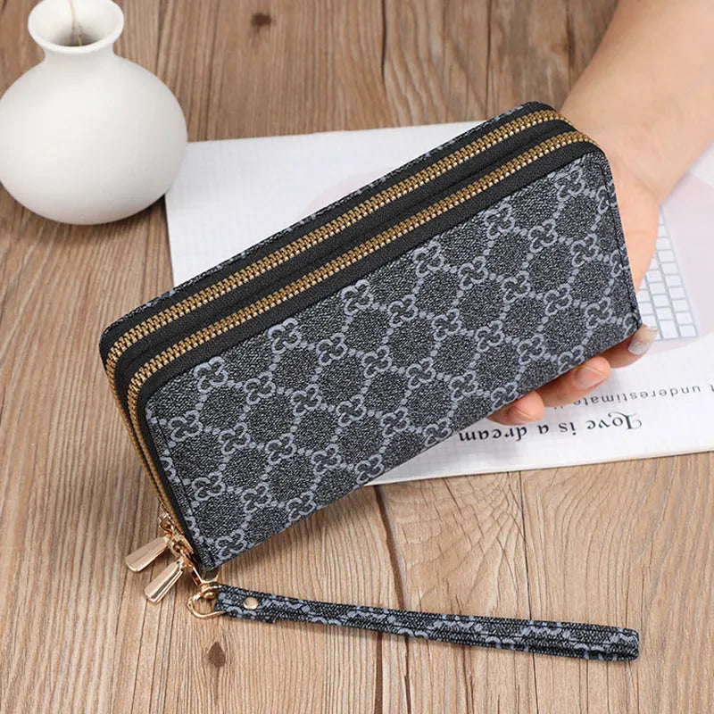 Long black PU leather wallet clutch with retro styling, open to show mobile phone compartment and coin purse sections